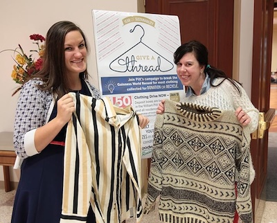 two people holding up clothing at an even