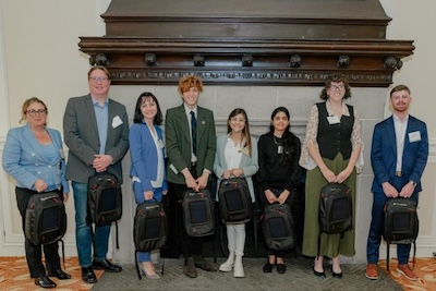 group of people holding backpacks