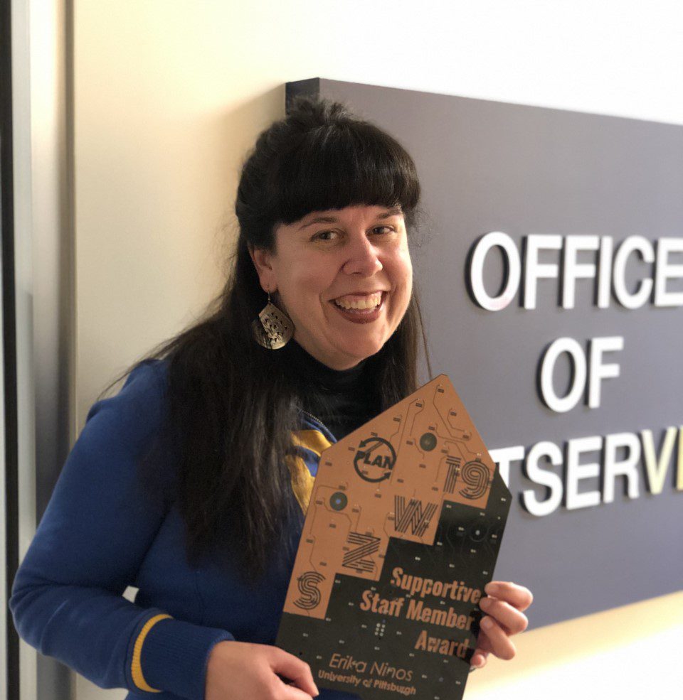 Erika Ninos holding award