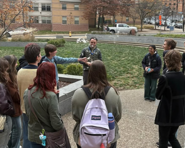 person shows how milkweed seeds spread to a crowd