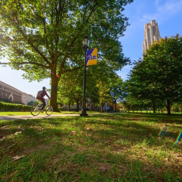 Student rides a bike on campus