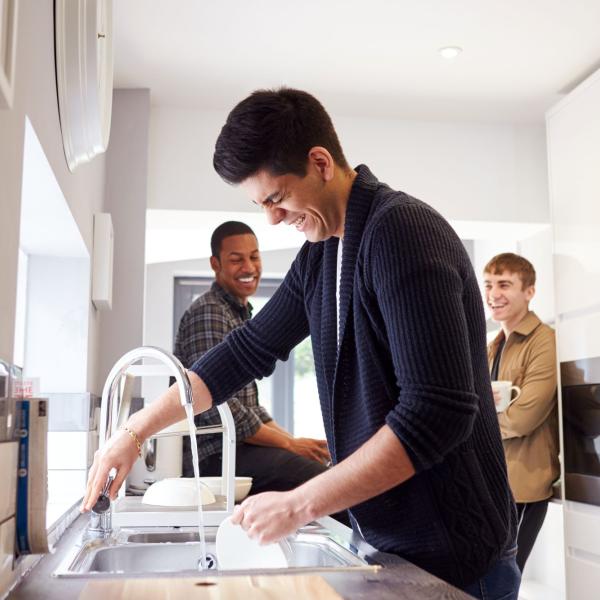 Three guys in a kitchen laughing