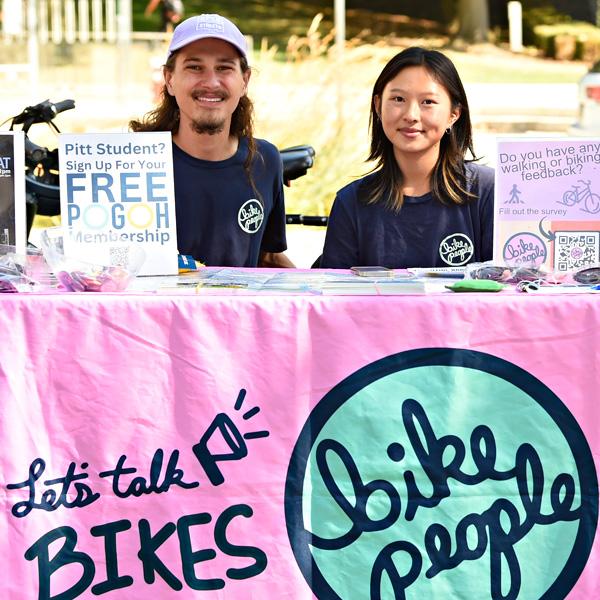 Students work at a table promoting bicycling.