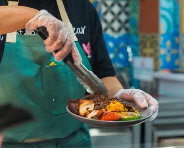 close-up of woman platting a meal