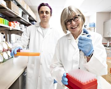 A professor and student work together in a lab.