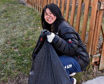 A student picks up garbage.