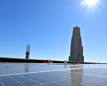 Solar roofing with the Cathedral of Learning in the background.