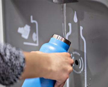Hand filling up a water bottle