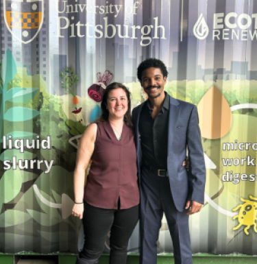 Aurora Sharrard and Kyle Wyche stand in front of an aneerobic digester at Pitt