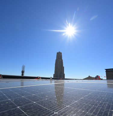 Solar panels on top of Ruskin Hall in front of the Cathedral of Learning