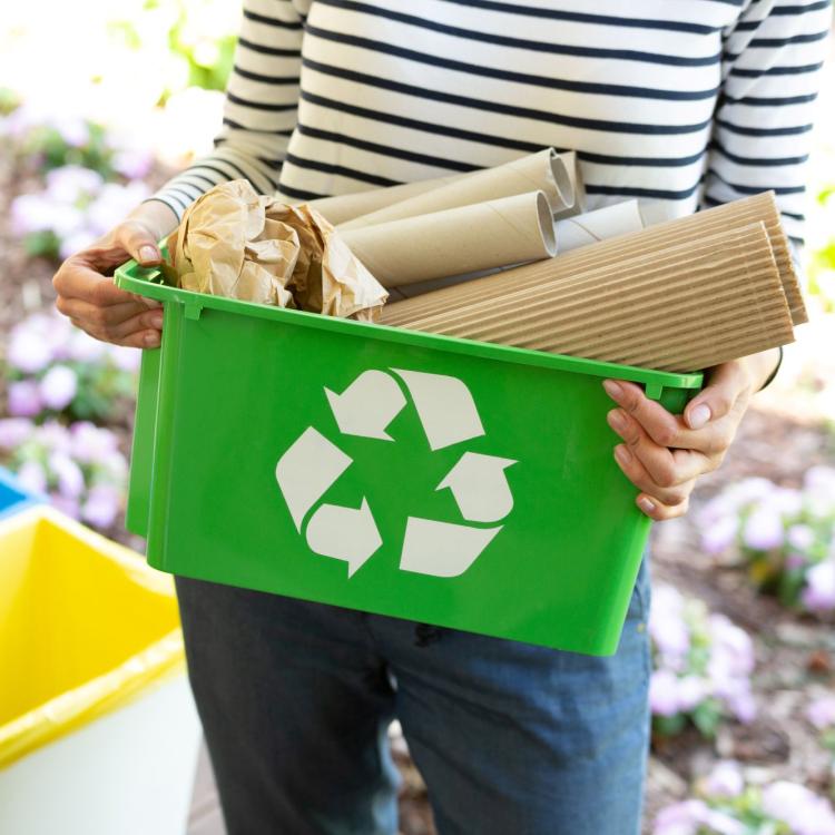 woman holding box of recycling