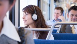 Woman wearing headphones on a bus